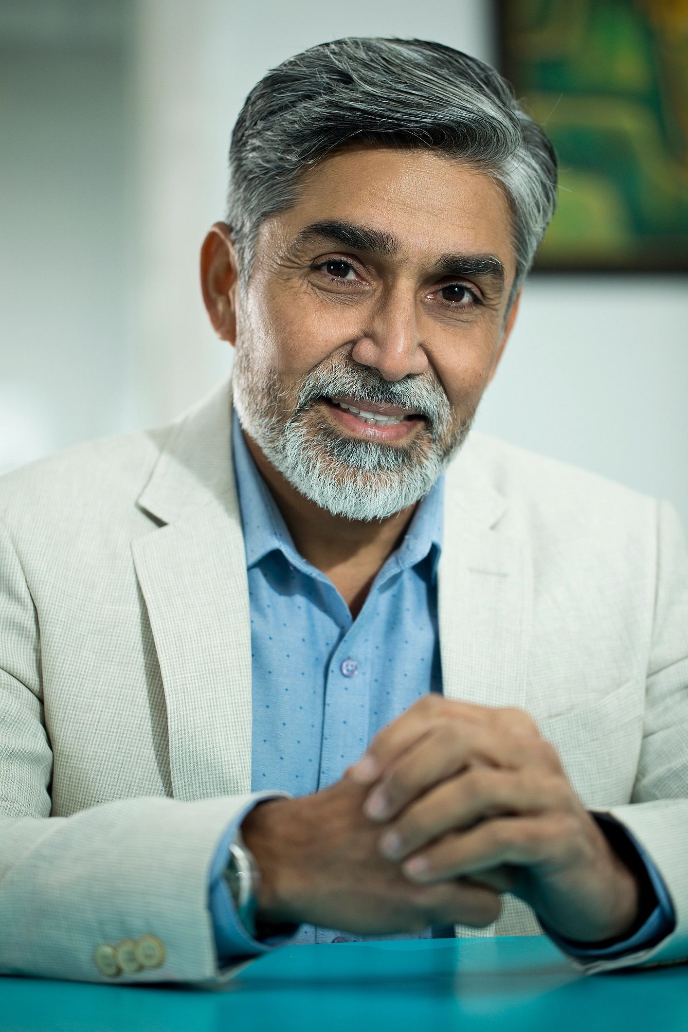 senior Indian male dermatologist professional portrait clinic